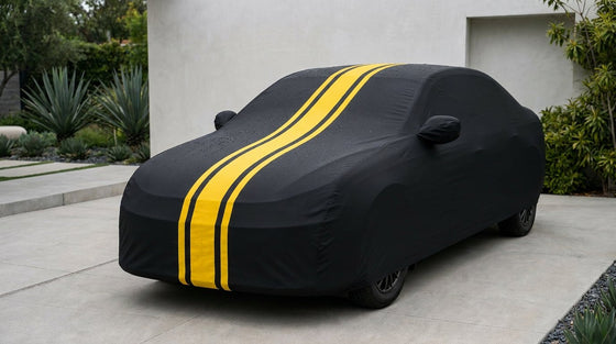 A car wearing a perfectly snug tailored black DriveCult body cover in a driveway