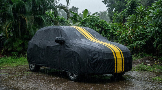 Compact SUV under a snug black DriveCult body cover in heavy monsoon rain