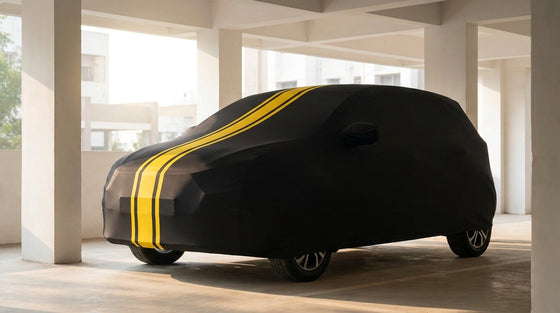 Maruti Suzuki Swift fitted with a matte black DriveCult Spyro car body cover with twin yellow stripes