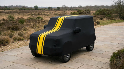 Mahindra Thar (3-Door) fitted with a matte black DriveCult Spyro car body cover with twin yellow stripes